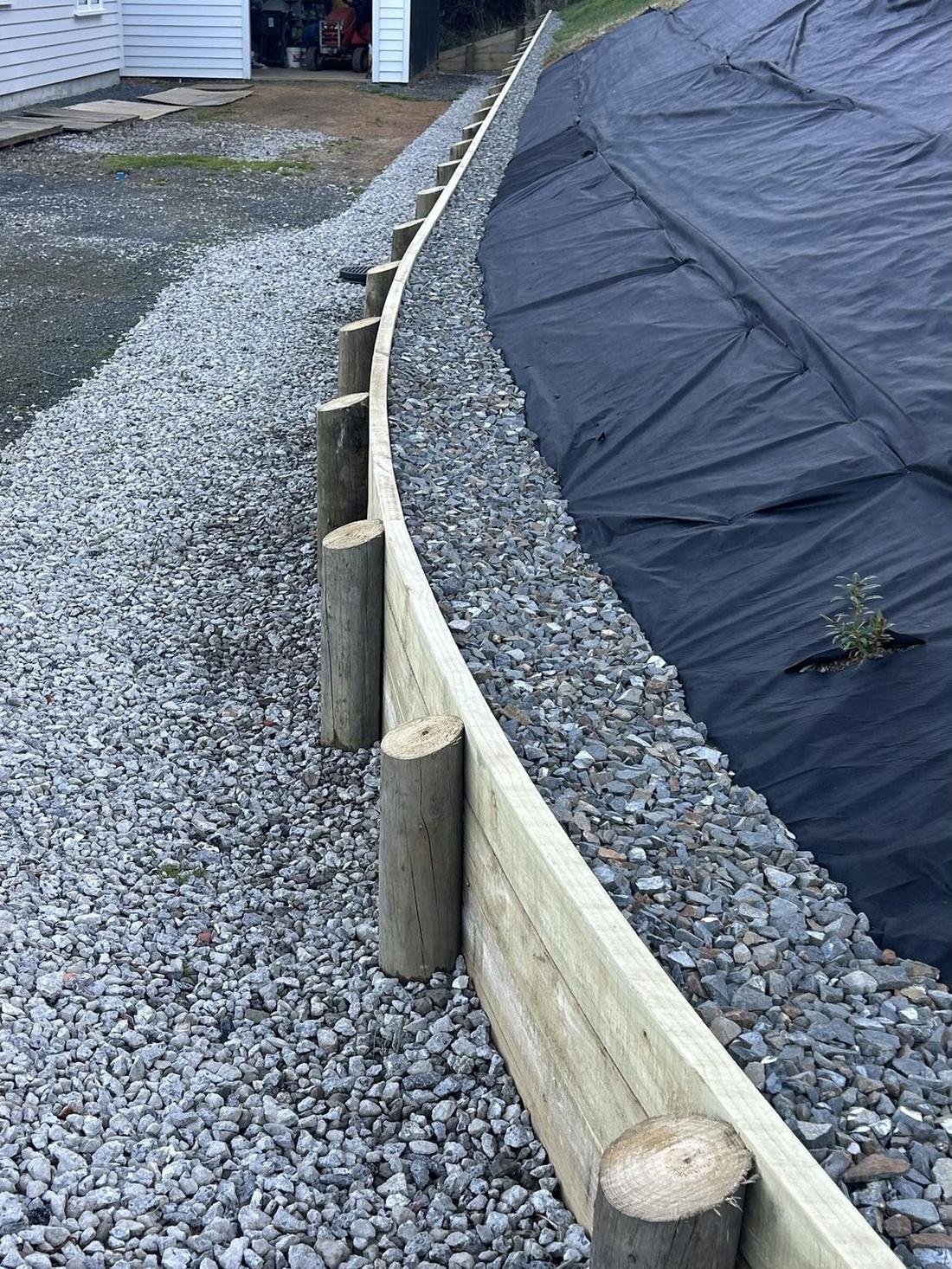 Curved timber retaining wall in Coatsville — driveway